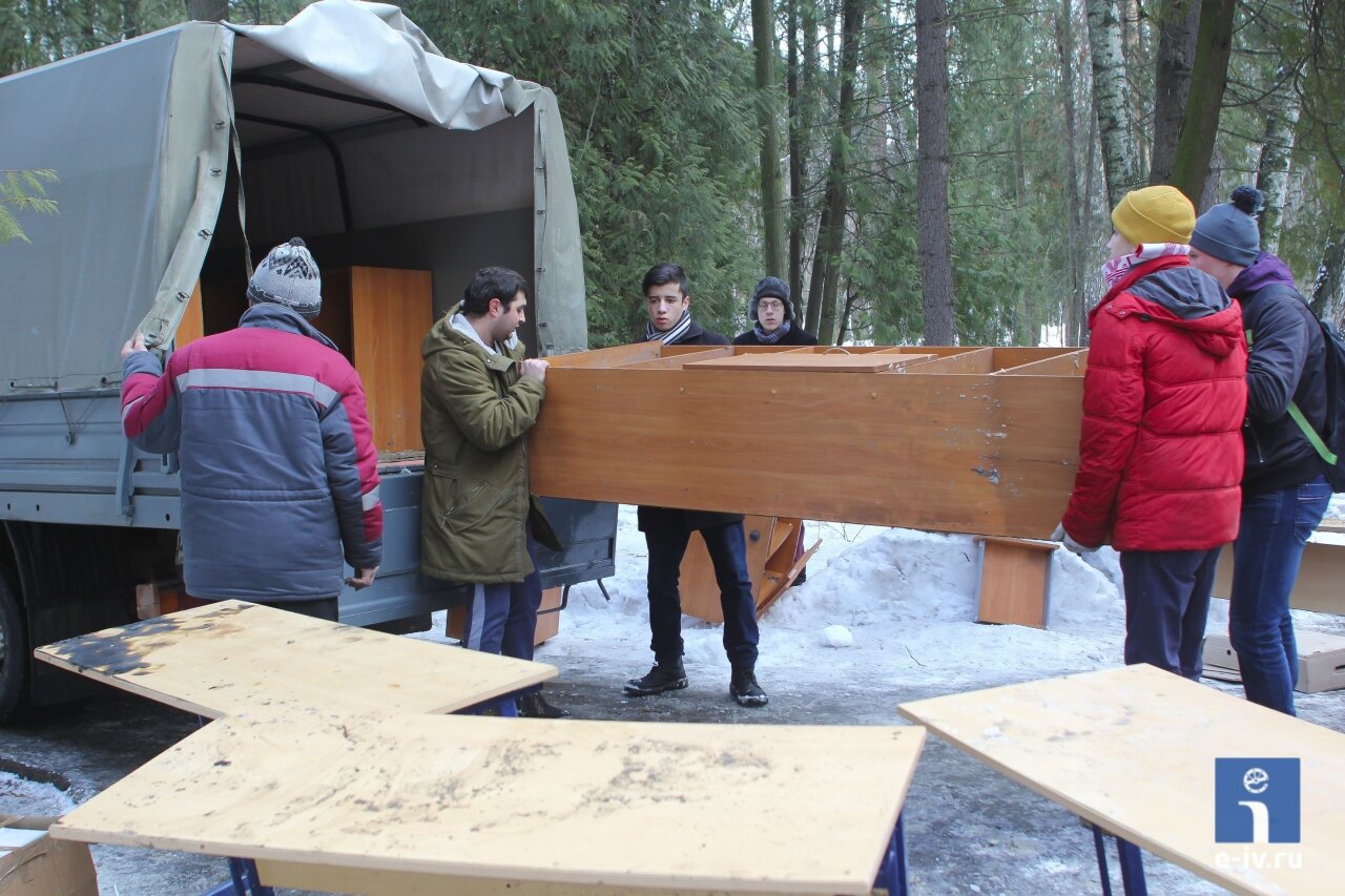 Волонтеры грузят в машину мебель, которая сохранилась после пожара в Пушкине
